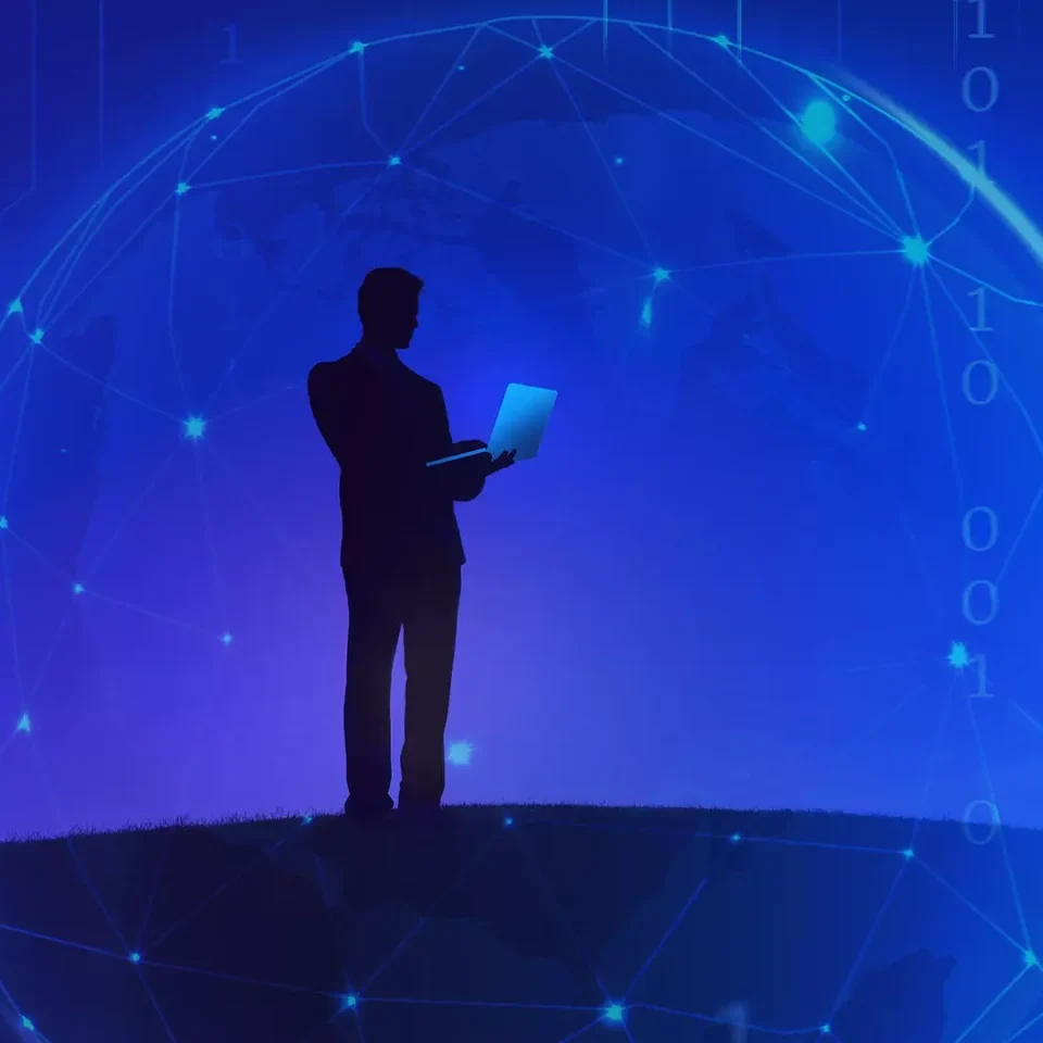 silhouette of a man with a lap top and a blue background with a digital globe